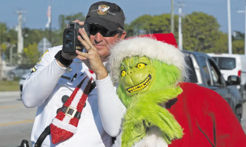 Deputy Dressed As Grinch Gives Onions